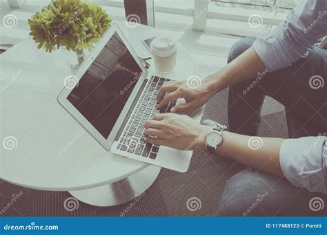 Man Using Laptop at Coffee Shop Stock Image - Image of laptop, phone: 117488123