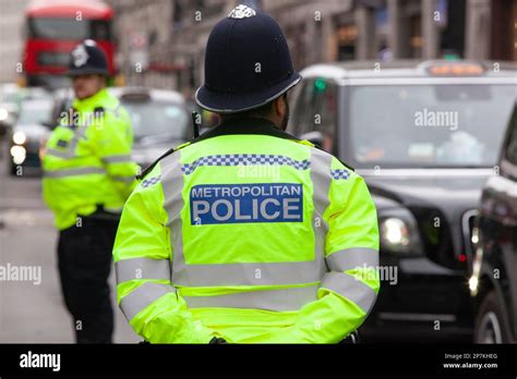 London, UK, 4 March 2023: Metropolitan Police officers in yellow-green ...