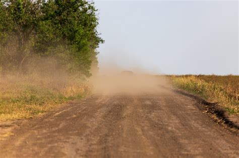 Premium Photo | A car in a cloud of dust, driving off into the distance ...