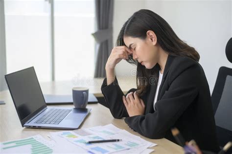 Stressed Young Business Woman Working on Laptop with Documents in ...