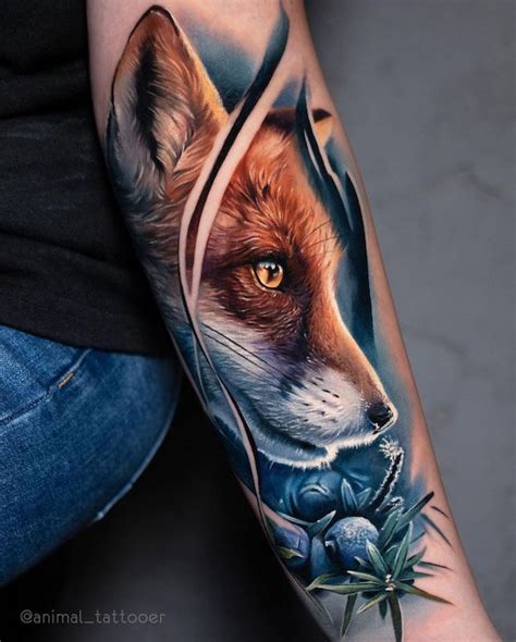 an arm tattoo with a fox and flowers on it