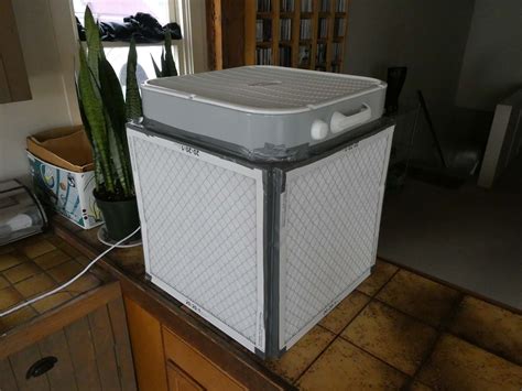 a cooler sitting on top of a kitchen counter next to a potted snake plant