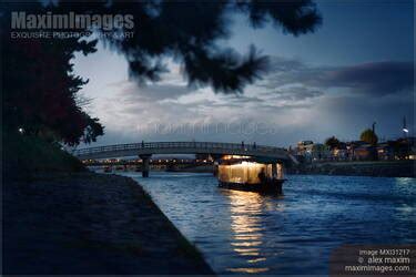 Photo of Sightseeing pleasure cruise boat illuminated with lights on Uji River at night | Stock ...