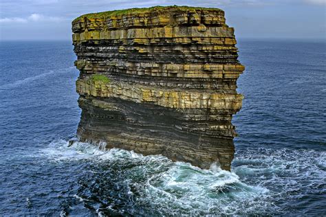 A photo of Dún Briste - a layered, chunky tower of rock rising off the ...