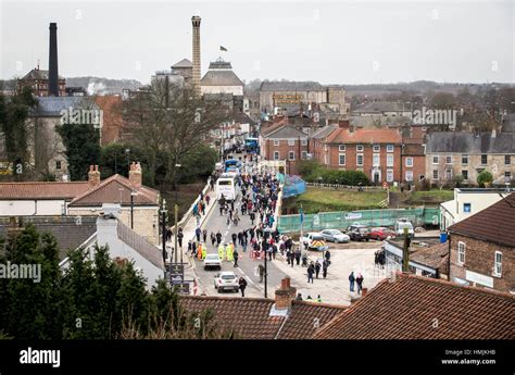 Members of the public cross Tadcaster Bridge as it reopens more than a ...