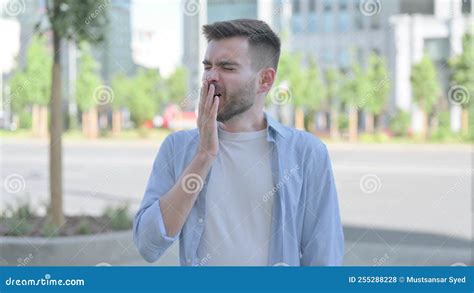 Outdoor Portrait of Sleepy Young Man Yawning Stock Photo - Image of ...