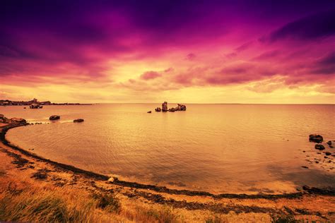 Purple sunset over beach with dramatic sky | royalty free image