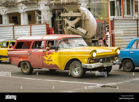 Cuba Old Havana La Habana Vieja old US American 1950's 50's estate car red yellow in motion ...