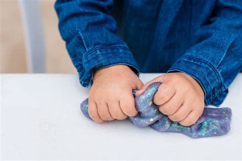 Child Crumples Slime. Close Up of Hands. Process of Making Slime. Blue ...