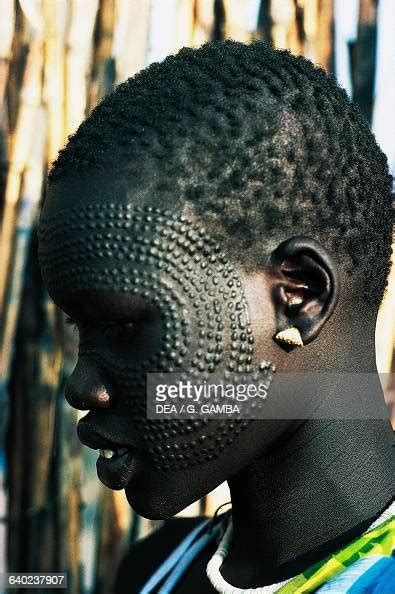 Young Nuer woman with ornamental scarification on her face, South ...