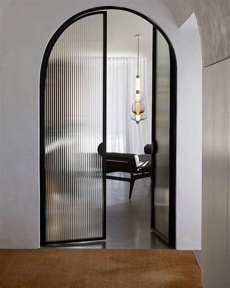 STUDIO BLACK INTERIORS on Instagram: “Arched steel doors with fluted ...