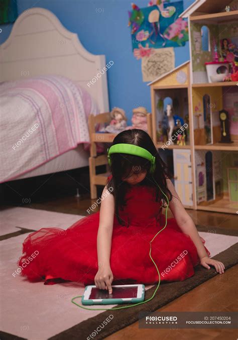 Girl listening music on digital tablet in bedroom at home — Tablet ...