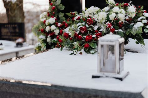 Flowers and a Candle on a Grave in Winter · Free Stock Photo