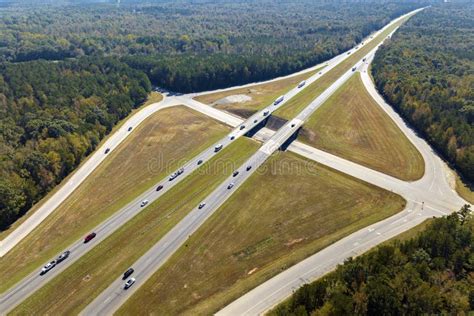 Elevated View of Freeway Exit Junction Over Road Lanes with Fast Moving Traffic Cars and Trucks ...