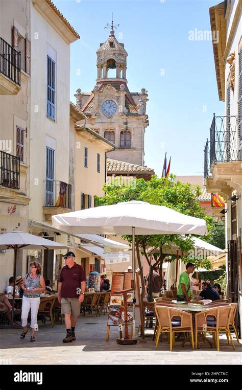 Street cafe and Ayuntamiento clock tower, Old Town, Alcudia, Alcudia Municipality, Mallorca ...