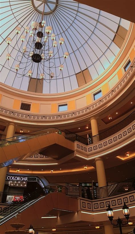 the inside of a large building with a skylight and chandelier hanging ...