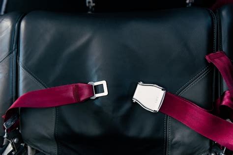 Premium Photo | Red seat belt in airplane on black seat unlocked safety prevention accident