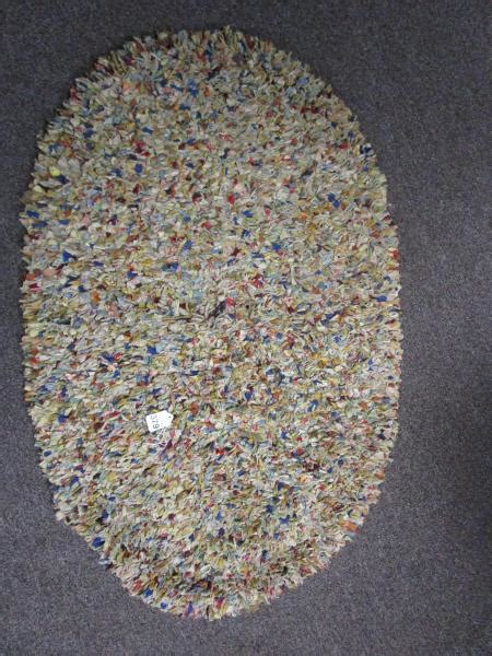 Sold at Auction: SMALL OVAL RUG