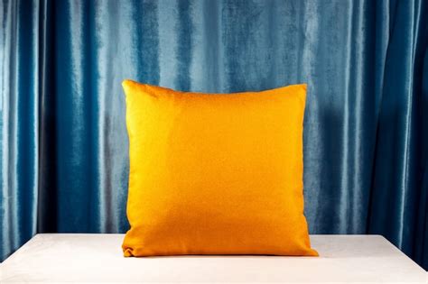 Premium Photo | Orange pillow on white desk