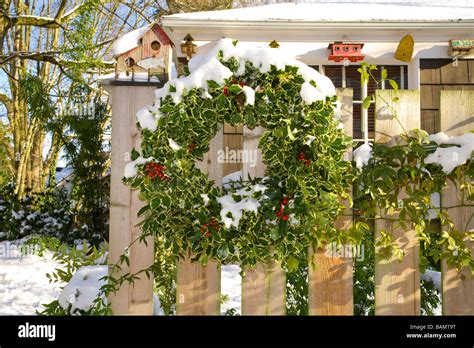 Christmas wreath on an outdoor fence Stock Photo - Alamy