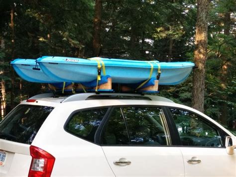 a white car with a blue canoe on top