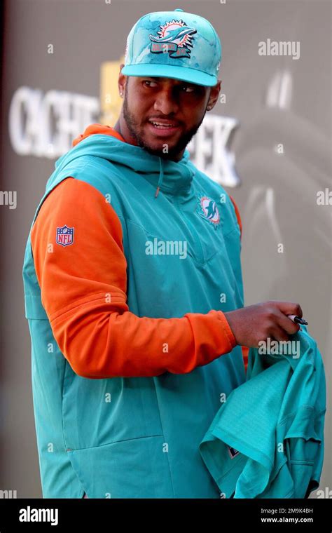 Miami Dolphins quarterback Tua Tagovailoa (1) signs an autograph during an NFL football game ...