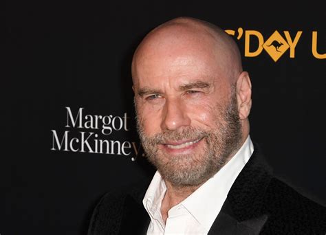 John Travolta debuts new shaved head