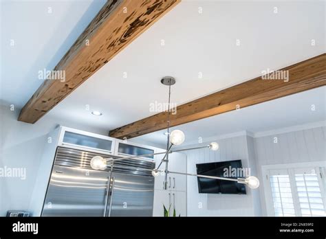 Wood beams in a white kitchen of a newly renovated house Stock Photo - Alamy