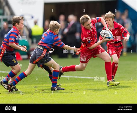 Teams of children playing tag rugby Stock Photo - Alamy