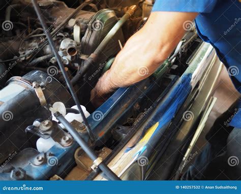 Mechanic Man in Uniform Repairing Car in Garage. Auto Repair Service ...