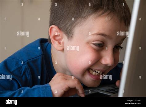 Joking child in front of touch screen laptop hi-res stock photography and images - Alamy