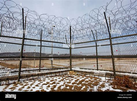 Barbed wire fence and South Korean flag at the DMZ, De-militarised Zone on the South North ...