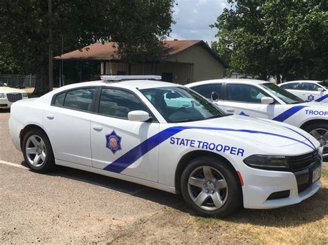 two state trooper police cars parked in a parking lot