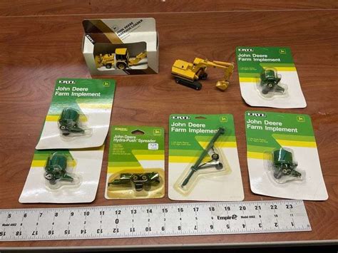 1/64 John Deere farm implements and construction - Legacy Auction Company