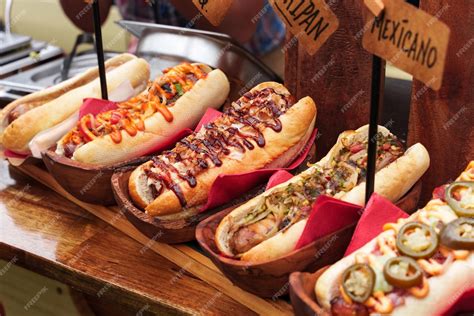 Premium Photo | Many hot dogs with various toppings and sauces Grilled hot dog sausage in a ...