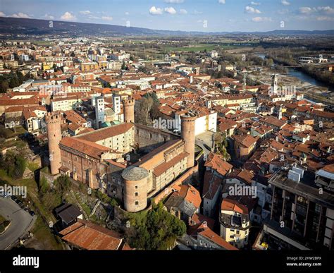 Aerial view of the historic centre with the Castle with its red towers in the foreground. Ivrea ...