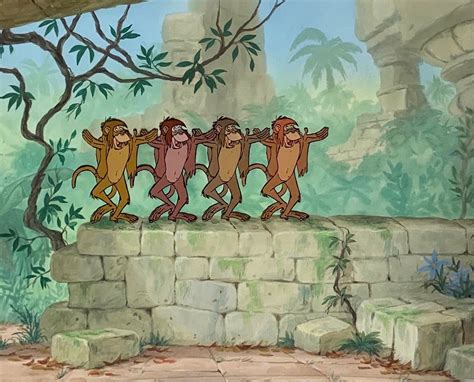 the three monkeys are dancing on top of a stone wall