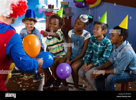 Clown playing with children during birthday party Stock Photo - Alamy