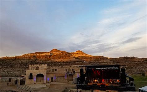 Sunset on the hills during a concert at the Badlands Amphitheatre. The Badlands Amphitheatre is ...