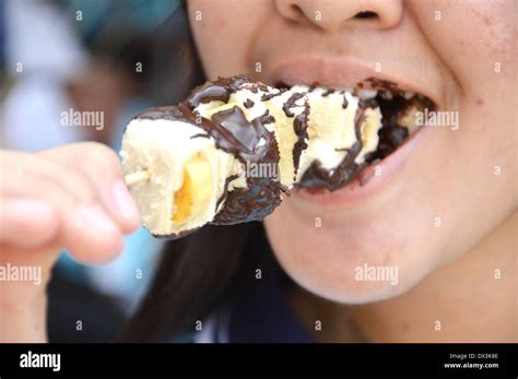 close up of mouth teenage girl eating cake Stock Photo - Alamy