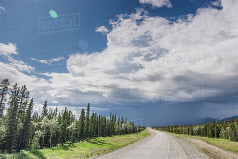 Scenic view of the Alaska Highway near Whitehorse with rain clouds in ...