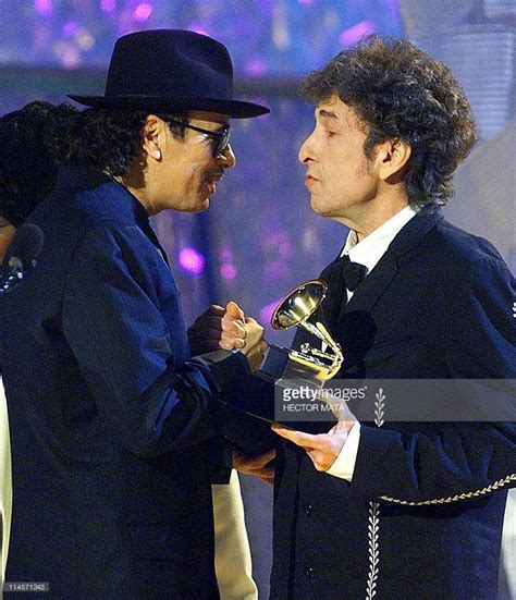 Singer Carlos Santana receives the award for the Album of the Year from ...