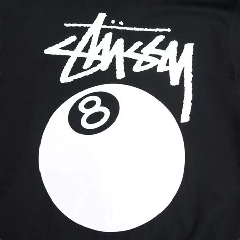 the back of a black shirt with white lettering and a eight ball on it's ...