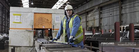 Portrait of male steelworker in industrial working environment — people ...