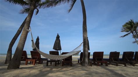 Beautiful tropical sea beach with umbrella chairs and a blue sky ...