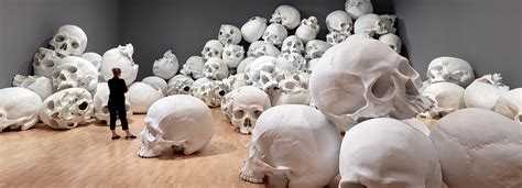 ron mueck stacks 100 sculpted skulls at the national gallery of victoria