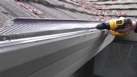 Installing Stainless Steel Gutter Guards on soft metal roof - YouTube