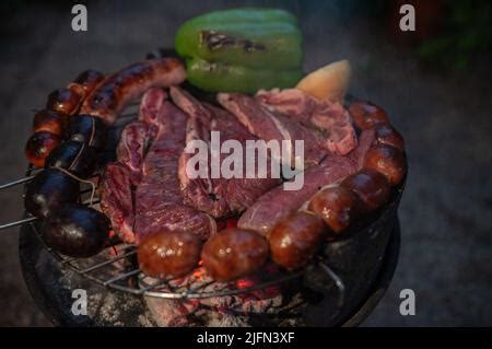 Typical Uruguayan and Argentine Asado Cooked on fire. Entrana and Vacio ...