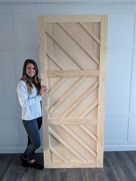 DIY Barn Door full tutorial using plywood, maple wood pieces and liquid nails from Lowe's. This ...