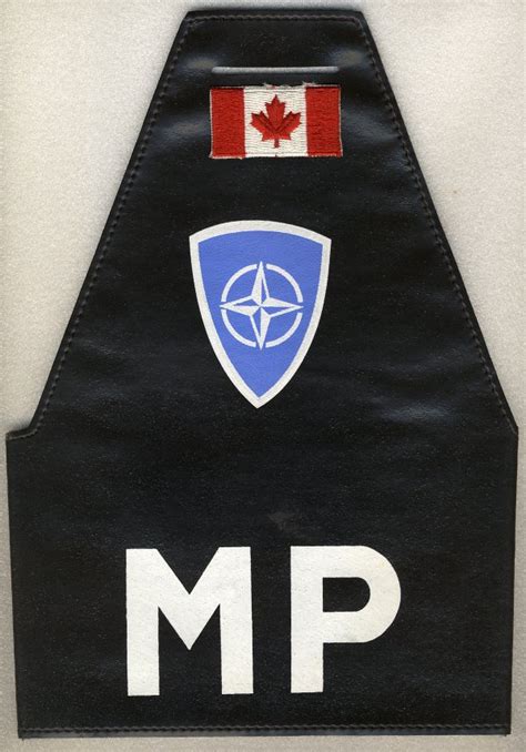 Combined NATO Military Police brassard with Canadian national identifier.